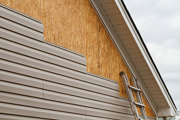 Professional Storm Damage Siding Repair technician working in Greenlawn, NY